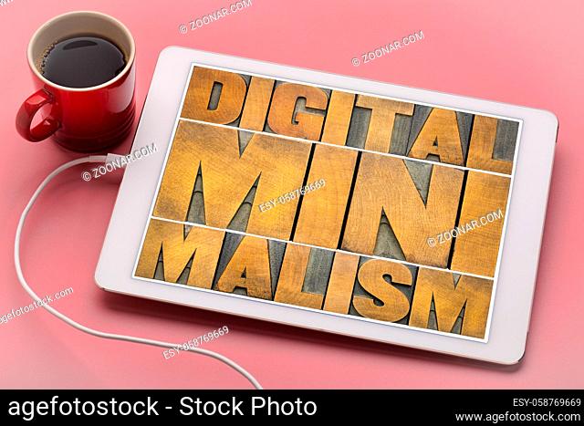 digital minimalism concept - word abstract in letterpress wood type blocks on a tablet with a cup of coffee