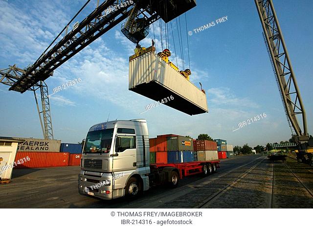 A crane loading container on a truck. Koblenz, Rhineland-Palatinate, Germany