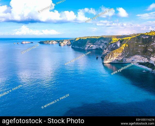 Indonesia. Penida Island. Sunny weather over coastal cliffs. Blue sky with clouds. Aerial view