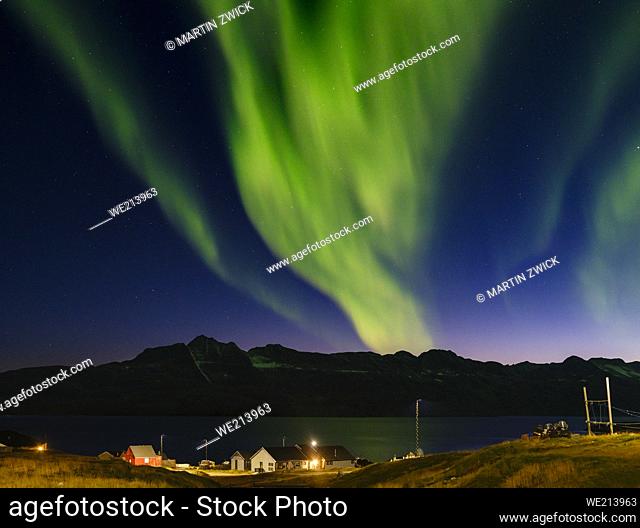 Northern Lights over settlement Kuummiit (formerly spelled Kummiut). Ammassalik area in East Greenland. North America, Greenland, Danish Territorrry