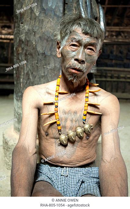 Naga headhunter, Longsha Wangnao, with chest tattoo marking him as having taken a head, and Naga necklace with tiger teeth, Nagaland, India, Asia
