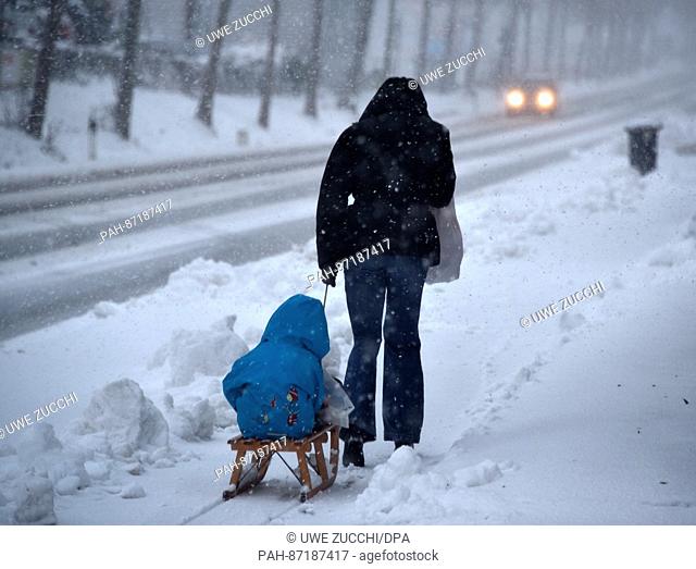 A woman pulls a child on a sled along a road near Mengeringhausen, Germany, 13 January 2017. The storm front 'Egon' did not cause any major damage in Northern...
