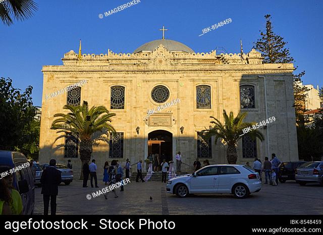 Agios Titos Church, facade, forecourt, people in the shade, car in the shade, blue cloudless sky, city centre, old town, Heraklion, capital, island of Crete