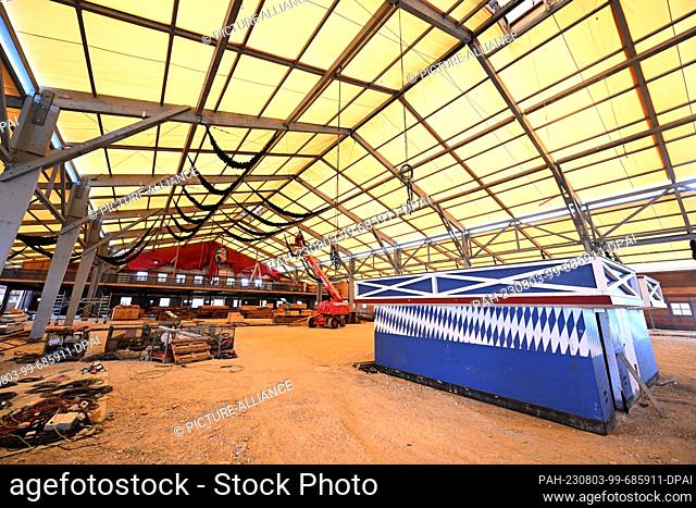 03 August 2023, Bavaria, Munich: In the Schottenhamel festival tent, where the traditional tapping takes place, the still unfinished stage stands during the...