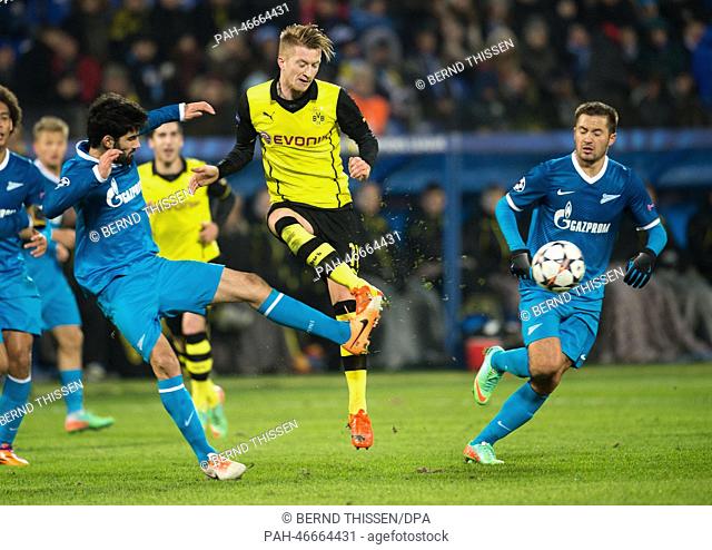 Dortmund's Marco Reus (C) vies for the Ball with Zenit's Luis Neto and Viktor Fayzulin (R) during the UEFA Champions League round of 16 first leg soccer match...