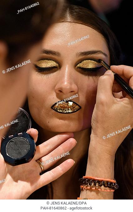A model gets her make-up done at the fashion show of the Austrian designer Rebecca Ruetz during the Mercedes-Benz Fashion Week in Berlin, Germany, 29 June 2016