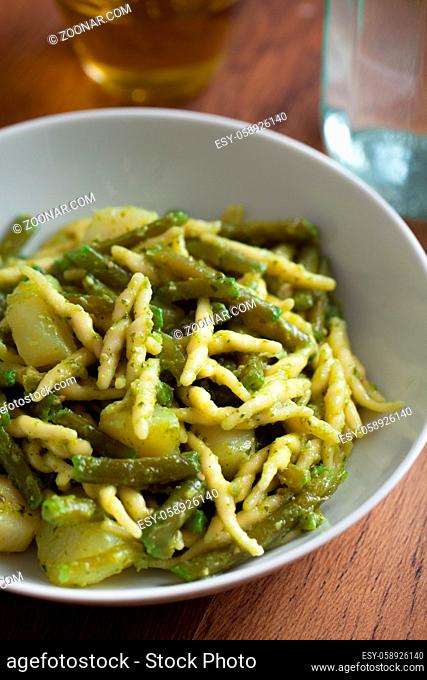 Pasta with pesto sauce on a plate