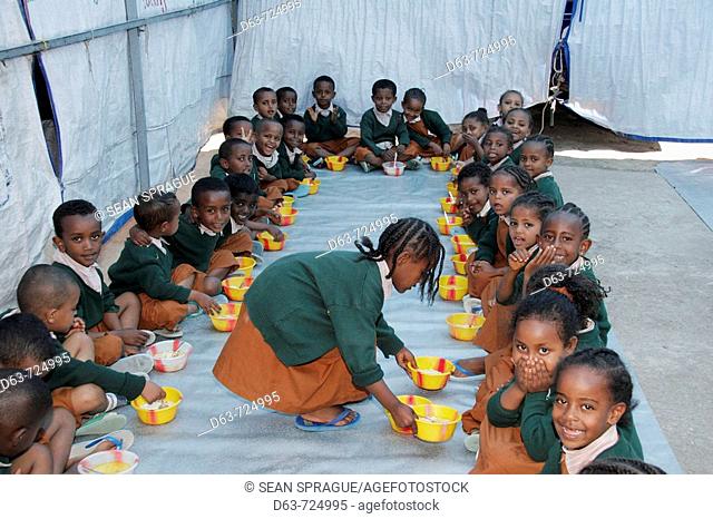 Children praying and eating lunch at the Bethlehem Centre pre school and day care, Addis Ababa, Ethiopia