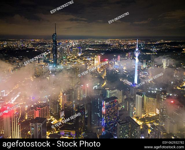 Bukit Bintang, Kuala Lumpur, Malaysia - Nov 12 2022: The view of the Merdeka 118 and KL tower's surrounding landscape during low cloud night provides a glimpse...