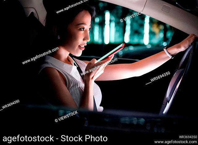 The use of cell phones young woman driving a car
