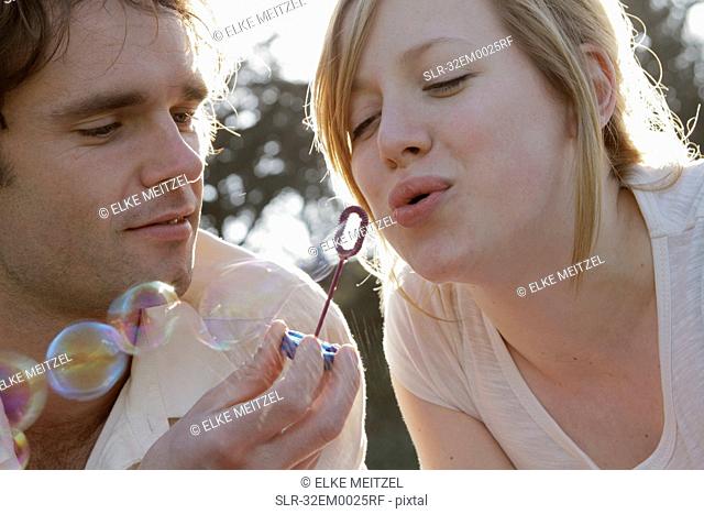 Couple blowing bubbles
