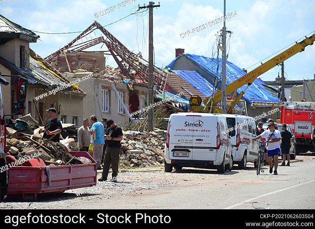 People clean debris after a tornado storm passed through the Luzice village in the Hodonin district, South Moravia, Czech Republic, pictured on June 26, 2021