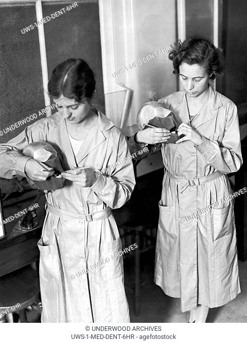 Philadelphia, Pennsylvania: c. 1926. Two students at work on dummy mouths in the oral hygiene clinic of the new Temple University Dental Infirmary