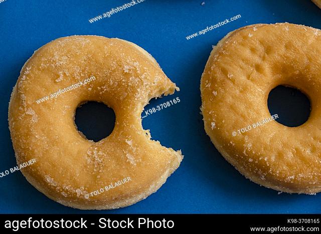 Bitten donut on blue background