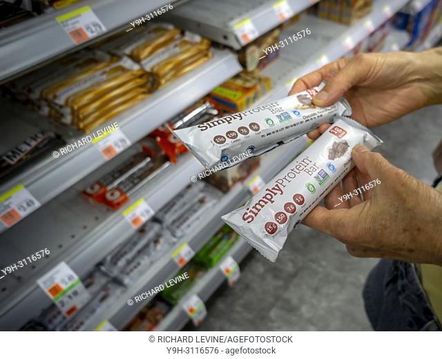 A customer decides on the flavor to buy of a Simply Good Foods Co. 's Simply Protein fband snack bar in a store in New York on Monday, July 9, 2018