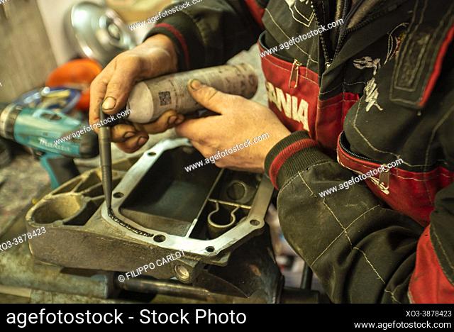 MILAN, ITALY: Mechanic repairs the gearbox