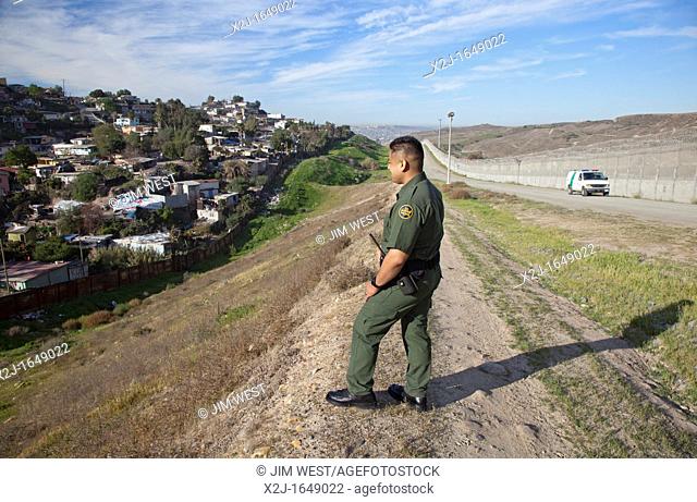 San Ysidro, California - U S  Border Patrol agent Joe Velasquez in the area between the old and new border fences between the United States and Mexico  A...