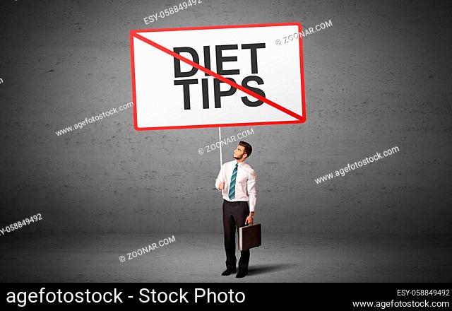 business person holding a traffic sign with DIET TIPS inscription, new idea concept