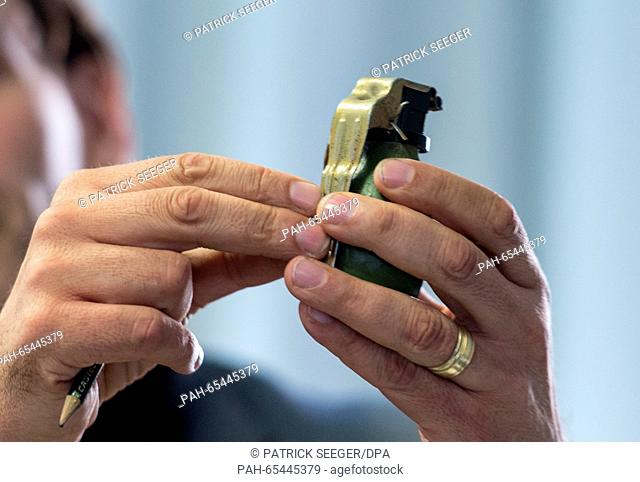 Chief Director Andreas Stenger from the Baden-Wuerttemberg State Criminal Office shows a model of the M52 hand grenade from the former Yugoslavia during a press...