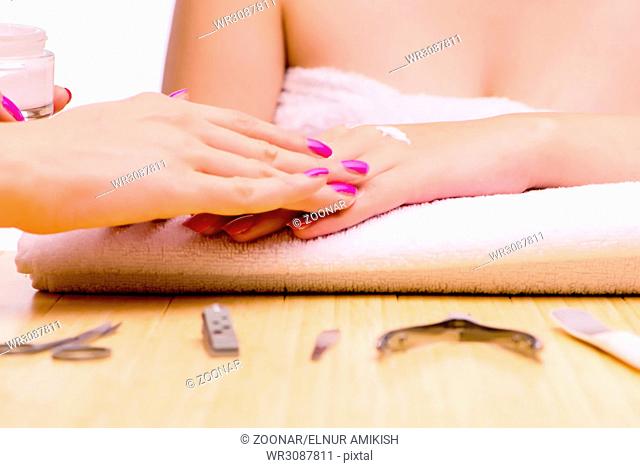 The woman hands during manicure procedure