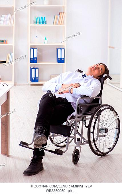 Doctor resting on wheelchair in hospital after night shift