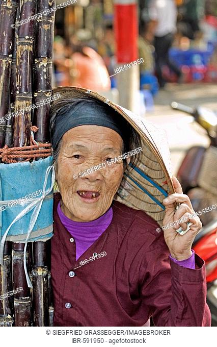 Old street vendor of sugarcanes in Hanoi, Vietnam