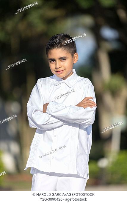 Elegant young man in white clothes posing for the camera in a photo shoot