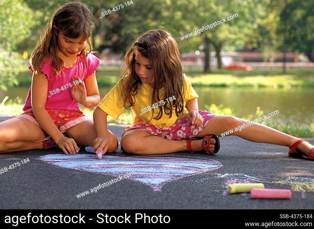 Young Sisters Create Chalk Art in the Park