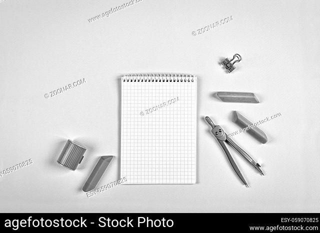 black and white. minimalism. concept school. Open school notebook and school chancery on a blue background. copy space. mock up. flat lay