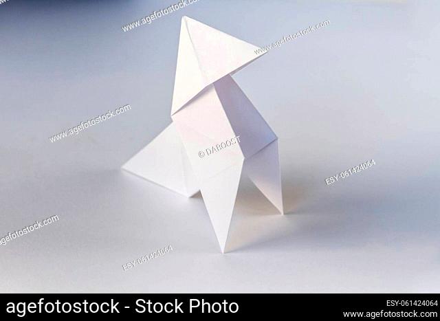 Paper hen origami isolated on a blank white background. Cocotte en papier