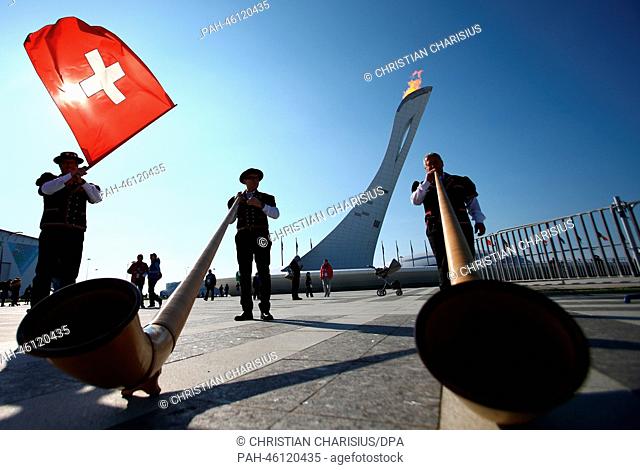 Swiss alphorn players from Engadin pose in front of the Olympic Flame in the Olympic Park at the Sochi 2014 Olympic Games, Sochi, Russia, 08 February 2014