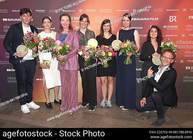 01 July 2022, Bavaria, Munich: The award winners show off with Diana Iljine (3rd from left), Director of Filmfest München, and Christoph Gröner (r)