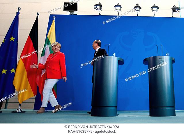 German Chancellor Angela Merkel (CDU, L) and the President of Myanmar, Thein Sein, leave after a press conference in the Chancellery in Berlin, Germany