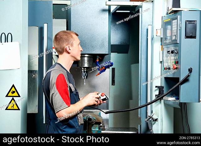 mechanical technician worker at metal machining milling center in tool workshop