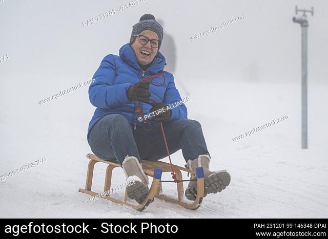 01 December 2023, Saxony, Altenberg: Barbara Klepsch (CDU), Minister for Culture and Tourism in Saxony, sits on a sledge at the Altenberg Adventure Mountain ski...