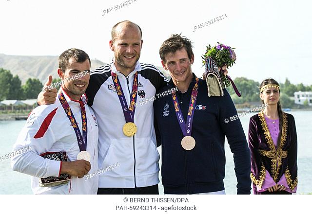 Max Hoff (C) of Germany poses with his gold medal next to silver medalist Fernando Pimenta (L) of Portugal and bronze medalist Cyrille Carre of France after the...