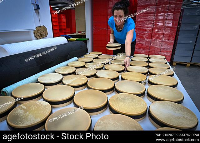 28 January 2021, Saxony, Markneukirchen: Marina Heberlein makes tambourines in the production of Rohema Percussion in Markneukirchen