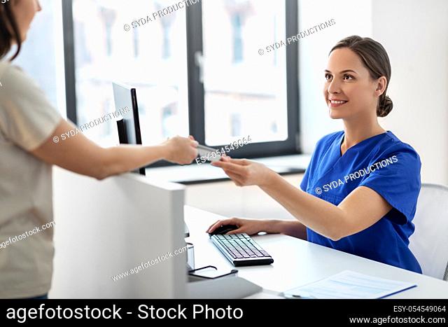 doctor and patient with credit card at hospital