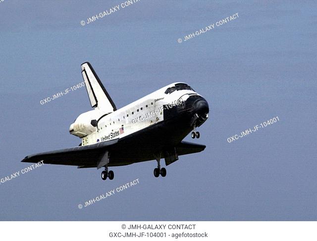 The Space Shuttle Endeavour's main landing gear is just about to touch down on Runway 15 at the Shuttle Landing Facility at the Kennedy Space Center (KSC)