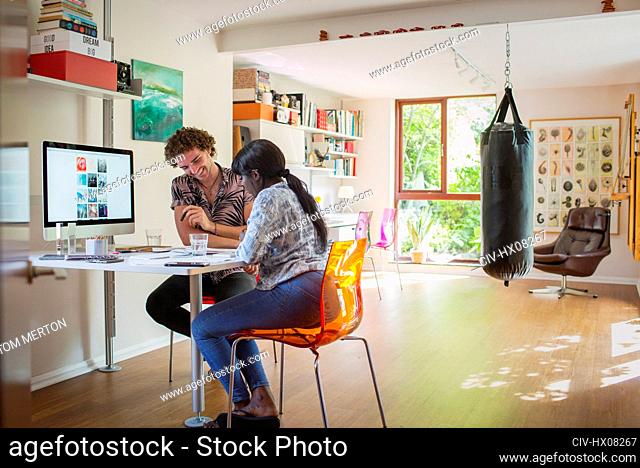 Happy young couple working in home office