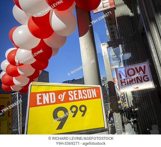 A clothing store in the Noho neighborhood of New York informs potential employees that it is hiring, as well as having an ""End of Season"" sale