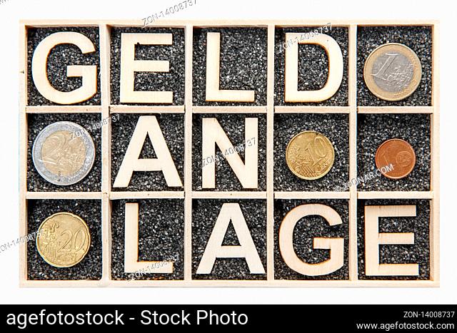 Wooden collection box with black decorative sand filled isolated subjects where the broken word MONEY PLANT is presented with plywood letters and different Euro...