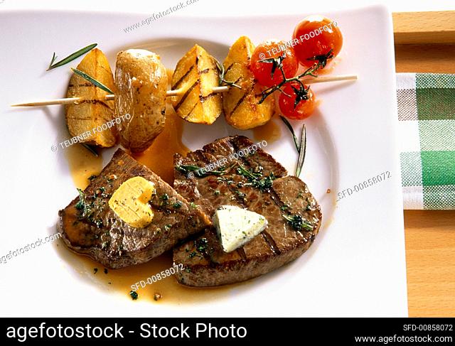 Grilled beef steaks with potato kebab