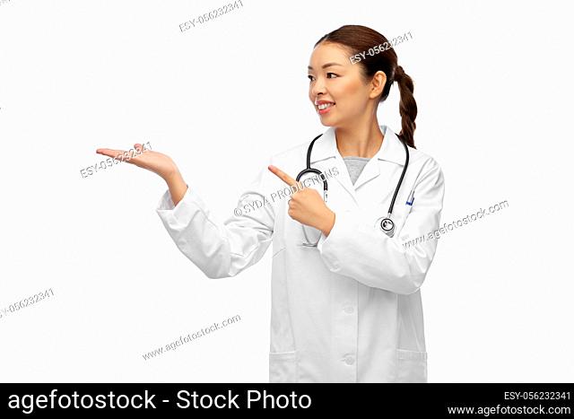 asian female doctor holding something on hand