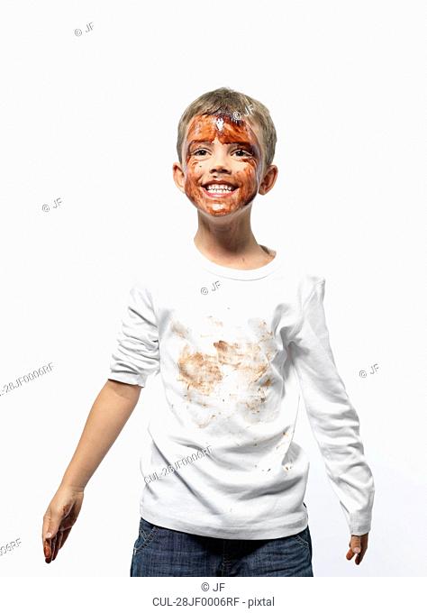 Boy covered in chocolate sauce