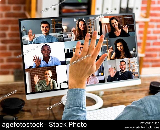 Hand Waving Hello On Video Conference On Desktop