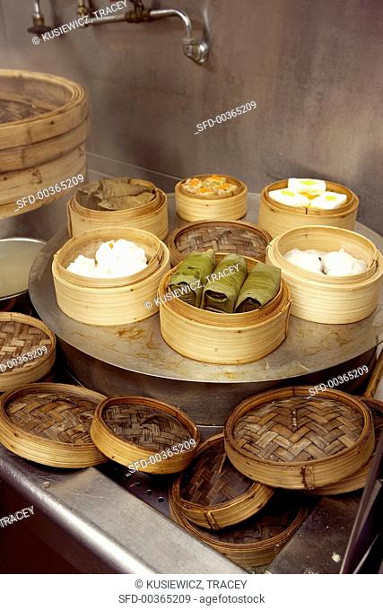 Assorted dim sum in bamboo steamers in eating house (Asia)