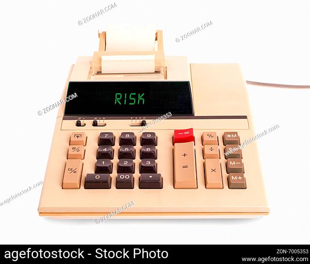 Old calculator showing a text on display - risk