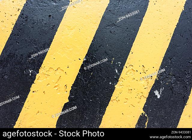 Yellow and black stripes on the concrete surface