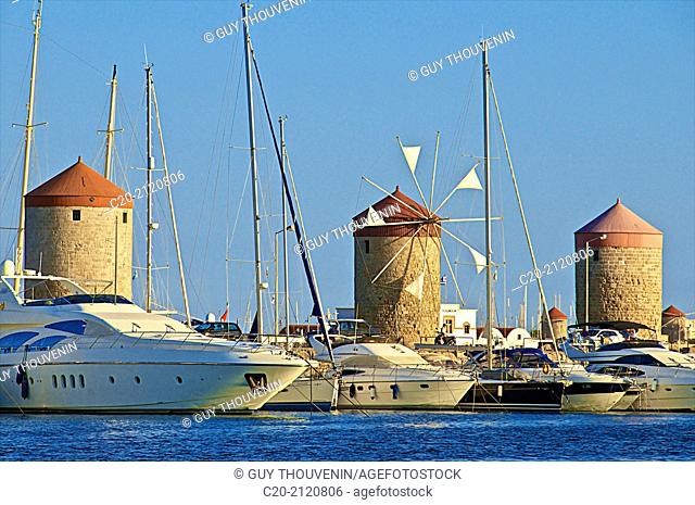 Windmills and tourists boats , in Mandraki harbor, Rhodes town , Rhodes island, Greece